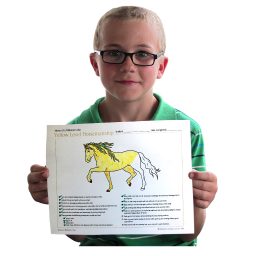 student holding Yellow Level certificate